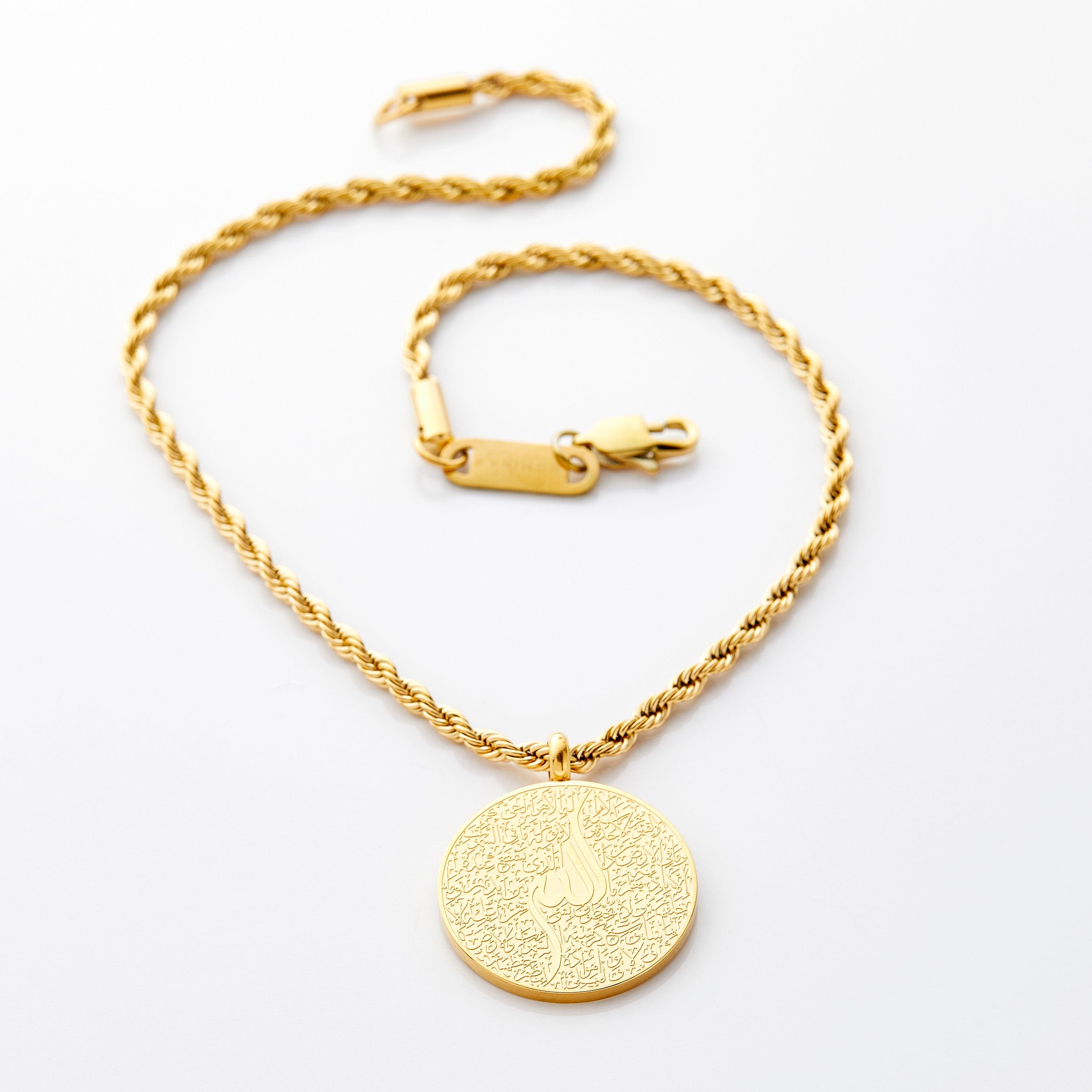 Gold car hanger with a circular pendant engraved in Arabic calligraphy of Ayatul Kursi, styled flat against a white background.