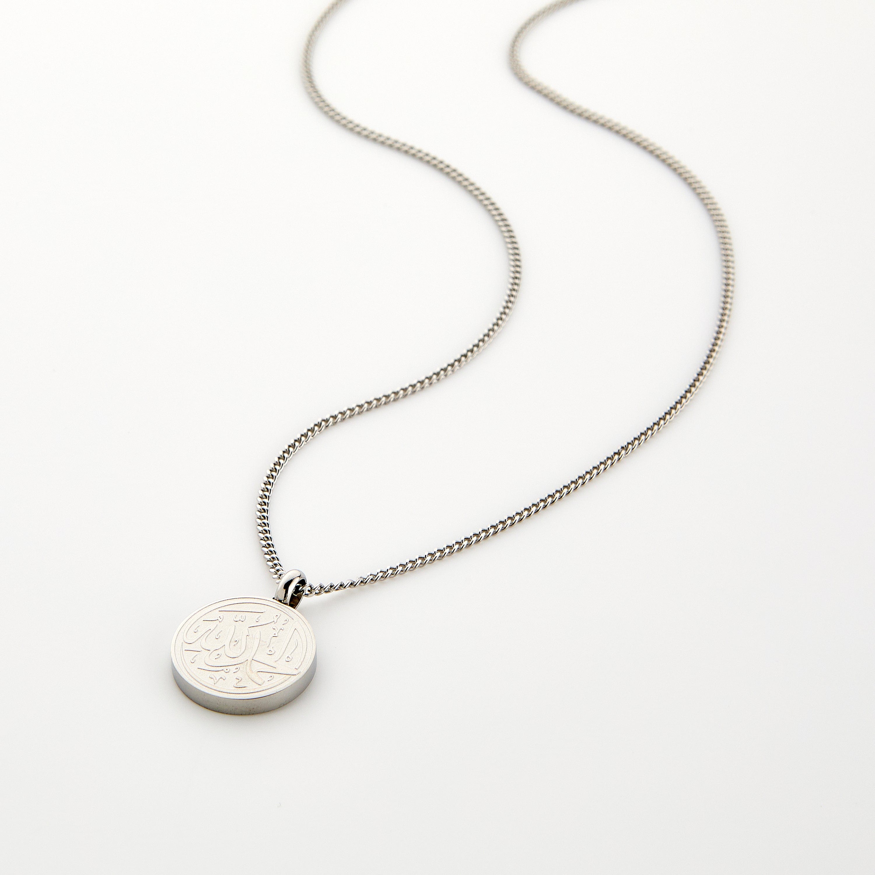 Silver necklace with a circular pendant engraved with 'Alhamdulillah' calligraphy, displayed on a white background.