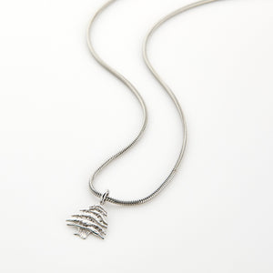 Silver necklace with a Cedar of Lebanon tree pendant, displayed on a white background.