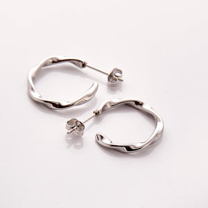 The Silver Ripple Hoop Earrings - Nominal against a white background.