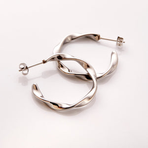 The Silver Ripple Hoop Earrings - Nominal against a white background.
