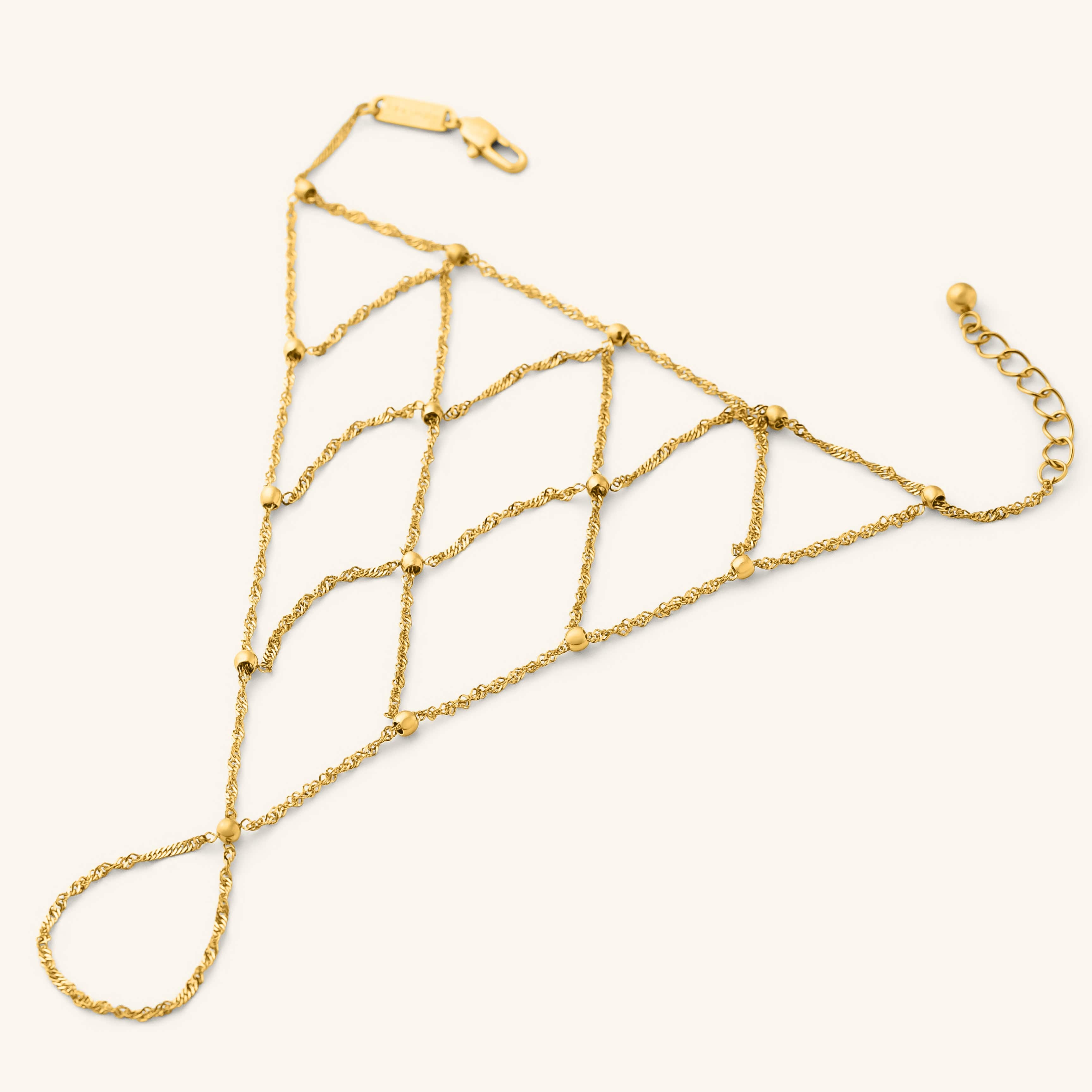 Gold Keffiyeh Fishnet Hand Chain featuring a lattice-style chain design with small gold beads.
