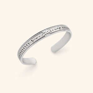 Slim silver cuff that has the individual patterns of Palestinian tatreez embossed into the cuff.