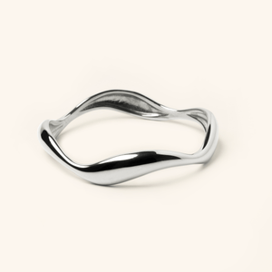 Photo of a silver Wave Bangle features cascading curves to remind you that life ebbs and flows.