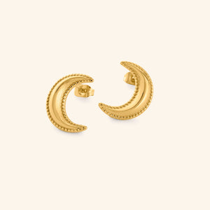 Gold crescent moon earrings with dotted design, shot on a white background