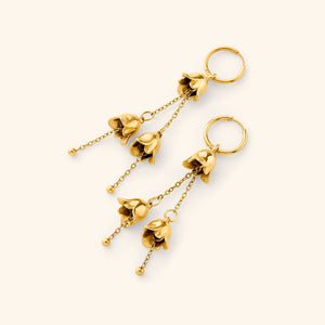 A pair of dangling Raining Tulip Hoops in gold, designed with delicate floral-inspired drops hanging from fine chains attached to small hoops.