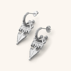 Silver Tatreez Earrings featuring textured geometric drops hanging from engraved hoop studs, shown against a neutral background.