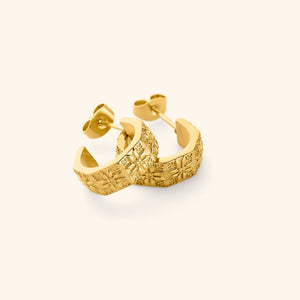 A pair of 18K gold plated thick hoop earrings traced with tatreez.