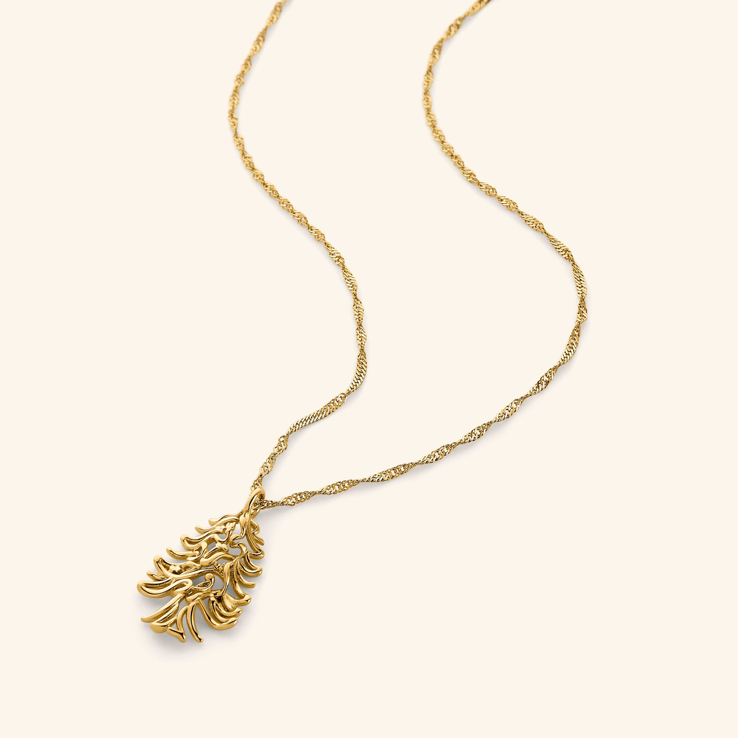 18k gold plated necklace featuring the Arabic phrase "Freedom is the soul", swirled into the shape of the Cedar of Lebanon tree on a thin twisted gold chain.