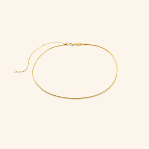 Gold harmony necklace on a white background