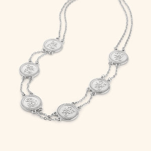 Silver layered necklace strung with coins stamped with إيمان (faith) in Arabic.