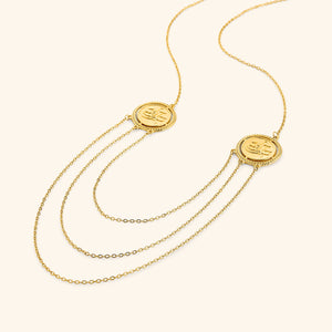 18k gold plated layered necklace featuring three chains of varying lengths connecting two tokens that say Salam (peace in Arabic)