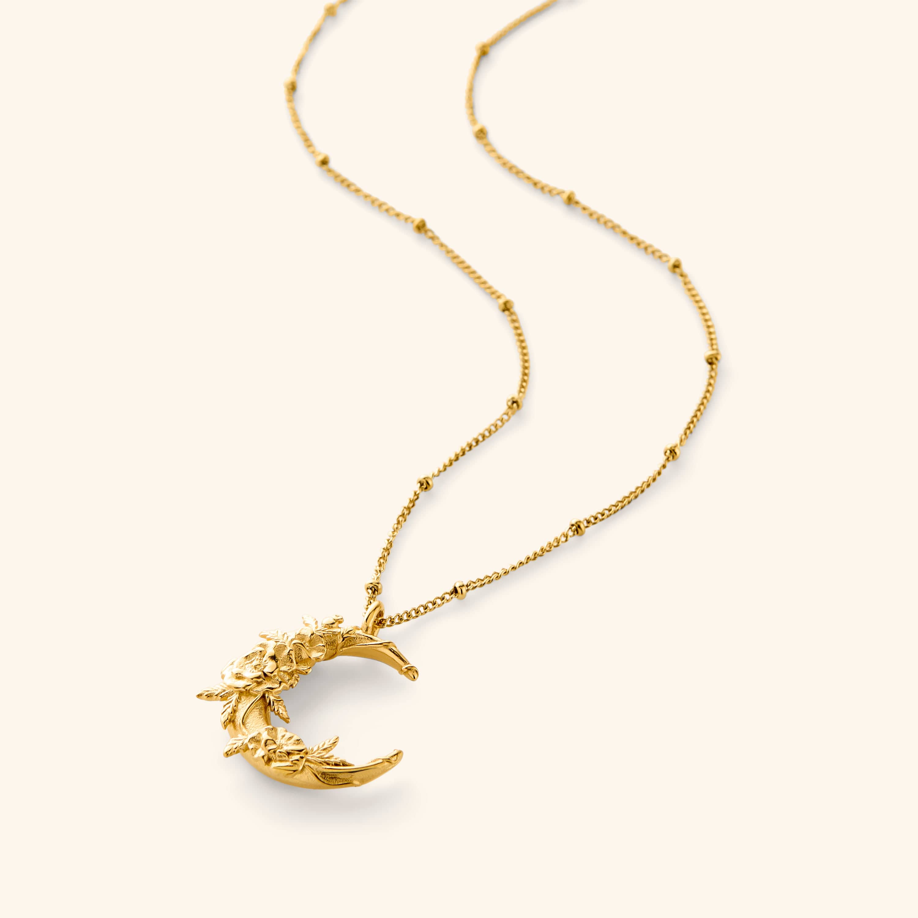 18K gold plated necklace. The pendant has poppy flower brought to the hopeful crescent on a thin dotted 18K gold plated chain.