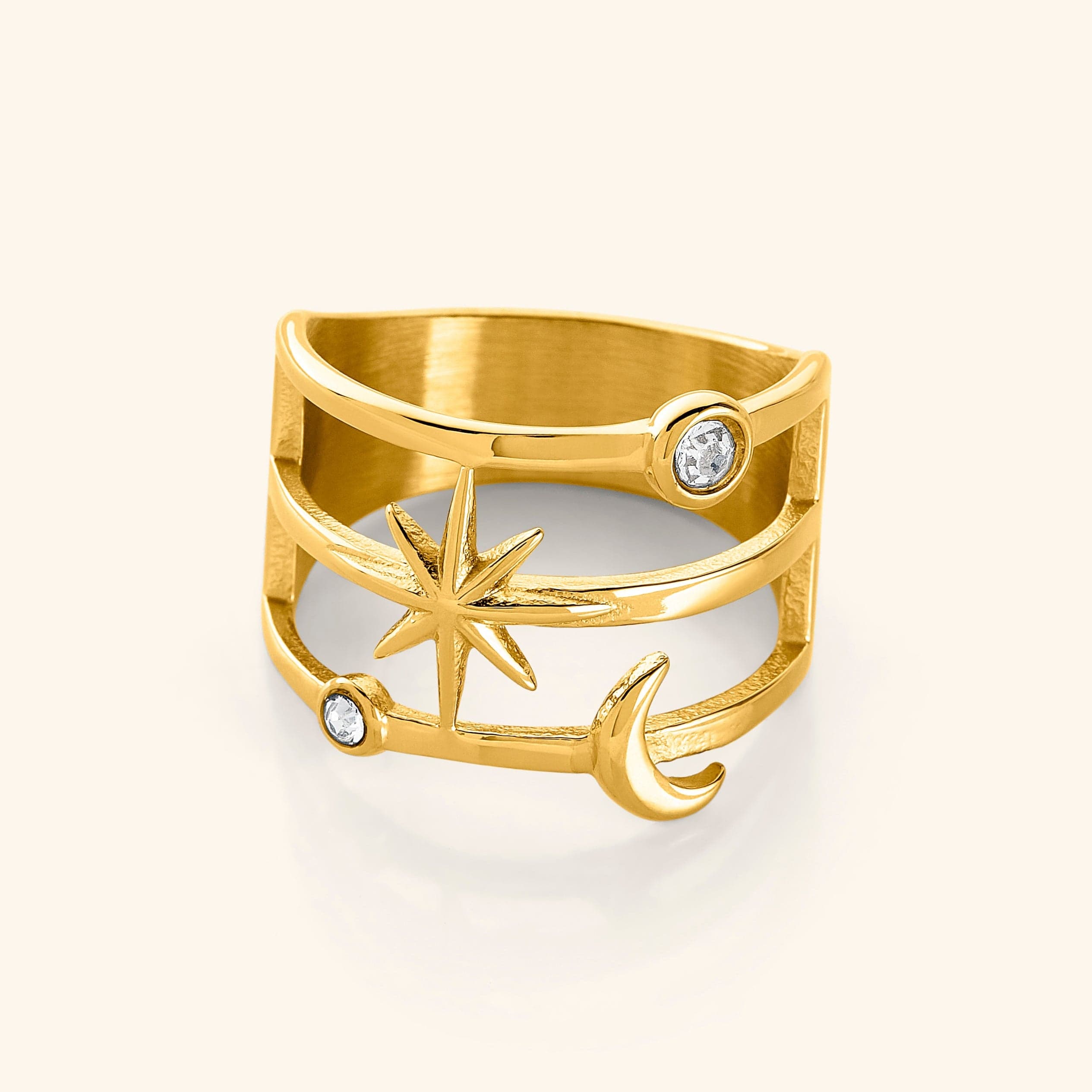 A close-up of the Galaxy Stack Ring in 18K gold plating. The ring features an openwork design with two luminous bezels, a radiant six-pointed star, and a delicate crescent.
