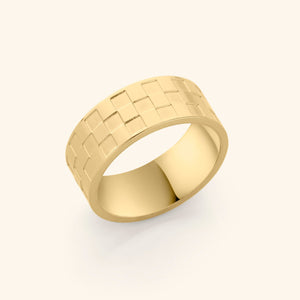 Gold Queen’s Ring with wide band featuring a raised square checkered pattern across the surface.