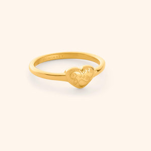 Gold ring with a heart-shaped design with calligraphy that reads "Quwa", shot on a white background