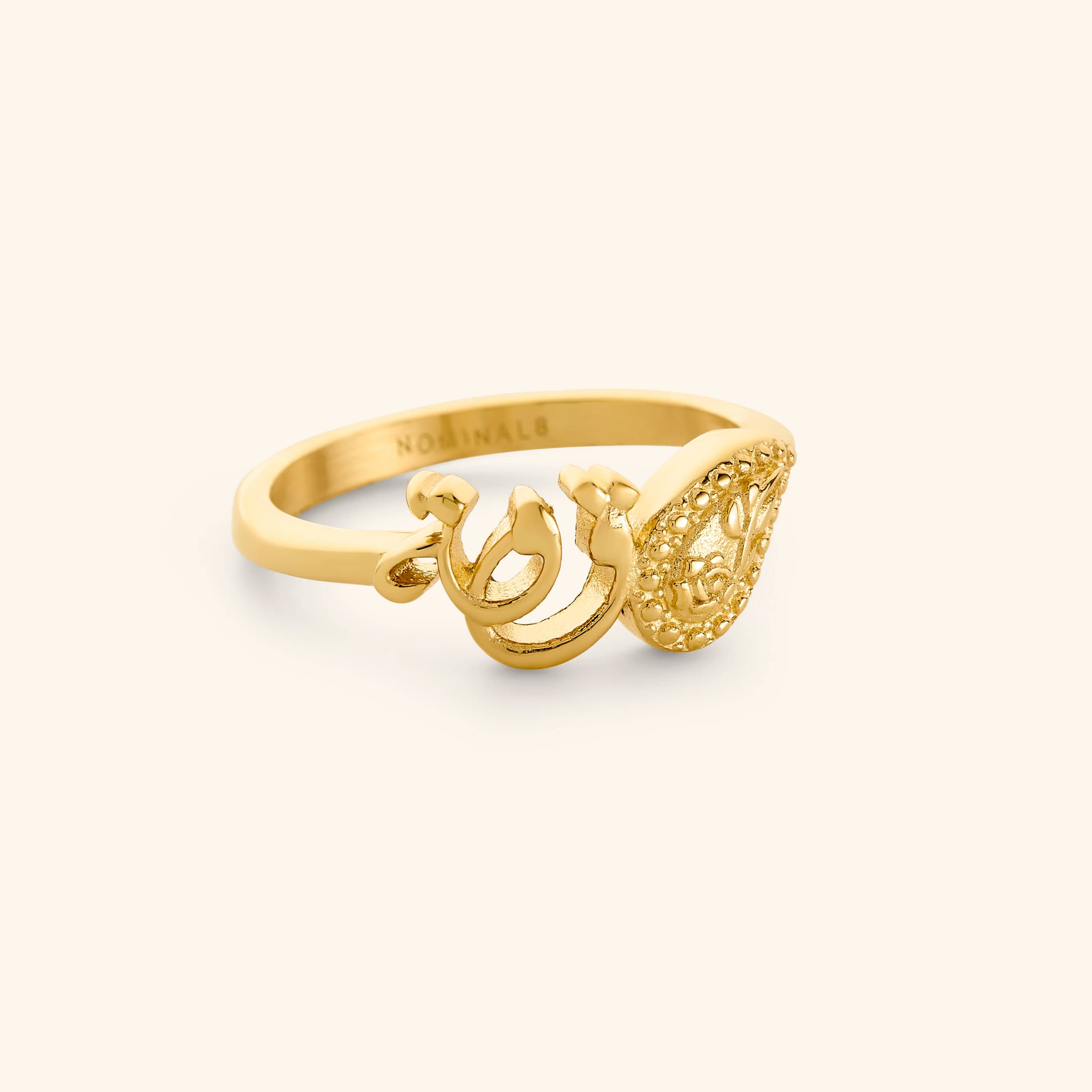 18K Gold plated minimal band ring with the word "strength" in Arabic Calligraphy and swirling paisley design. Inside ring engraving reads "Nominal"
