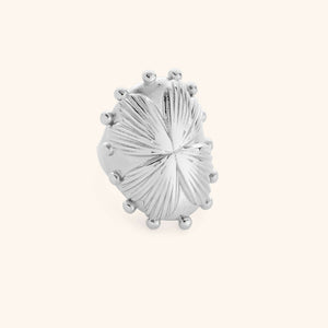 Close-up of silver regal garden ring with textured leaf design and raised bead accents.