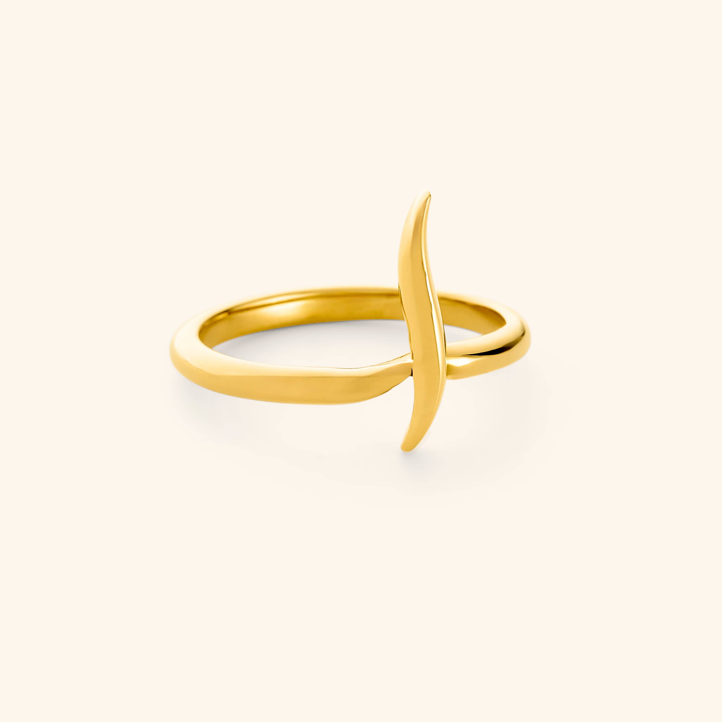 An 18k gold plated ring featuring a single Arabic letter wrapped around a timeless band.