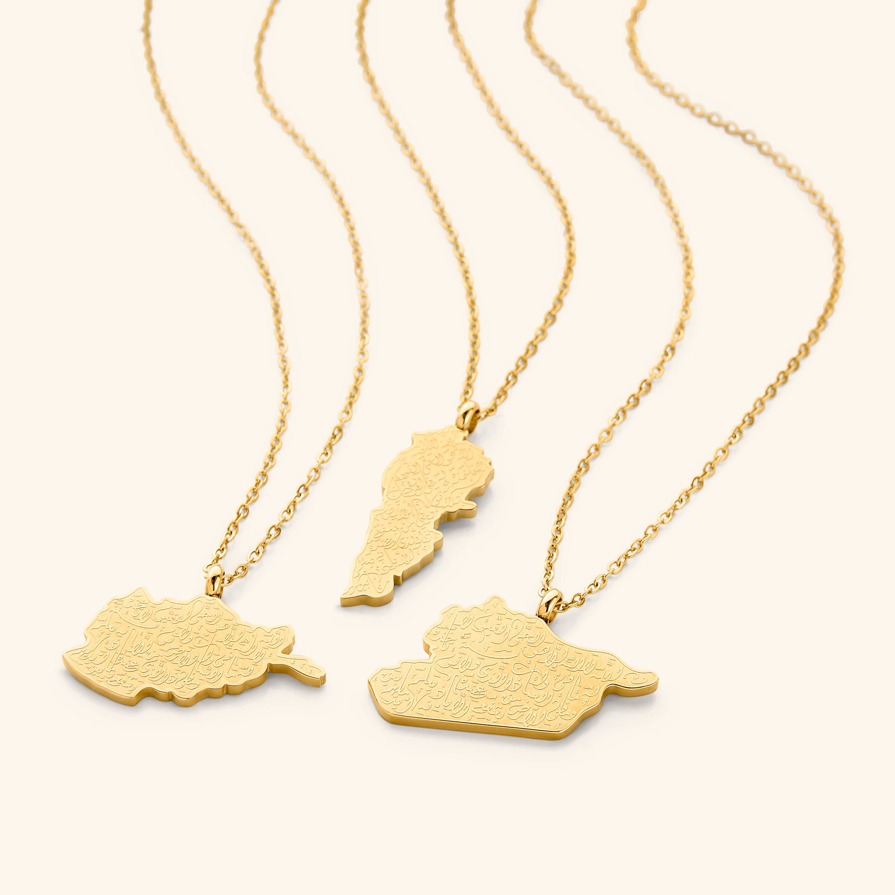 A close-up shot of the pendant, showcasing the detailed Arabic engraving of Ayatul Kursi on the gold-plated country-shaped pendants.