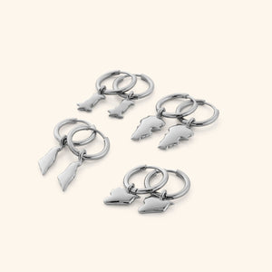 4 different pairs of silver hoop earrings that features outlines of different countries.