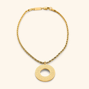 Gold circular car hanger with an open circle center, engraved with Duaa Al-Safar in Arabic calligraphy on a neutral background.