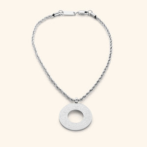 Silver circular car hanger with an open circle center, engraved with Duaa Al-Safar in Arabic calligraphy on a neutral background.