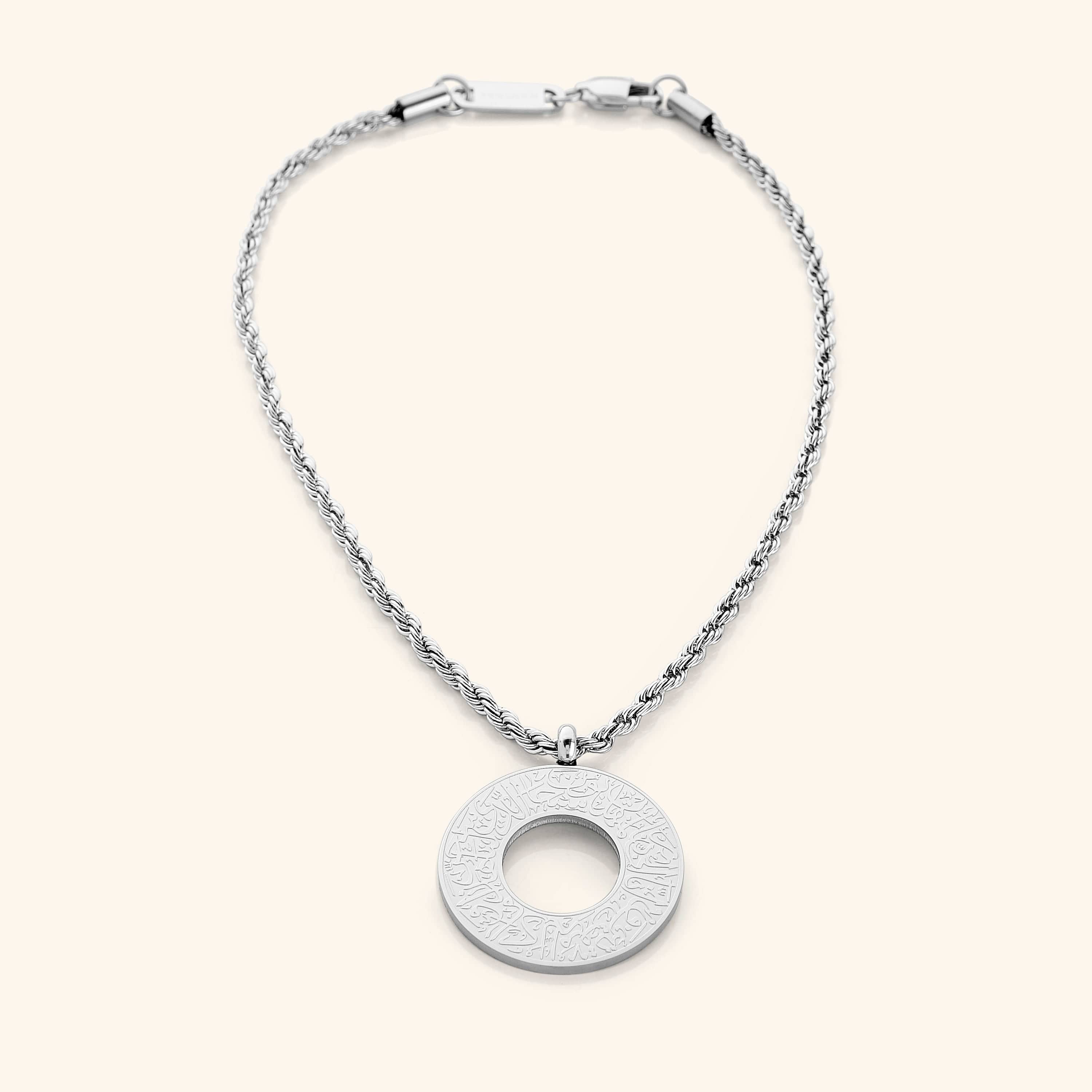 Silver circular car hanger with an open circle center, engraved with Duaa Al-Safar in Arabic calligraphy on a neutral background.