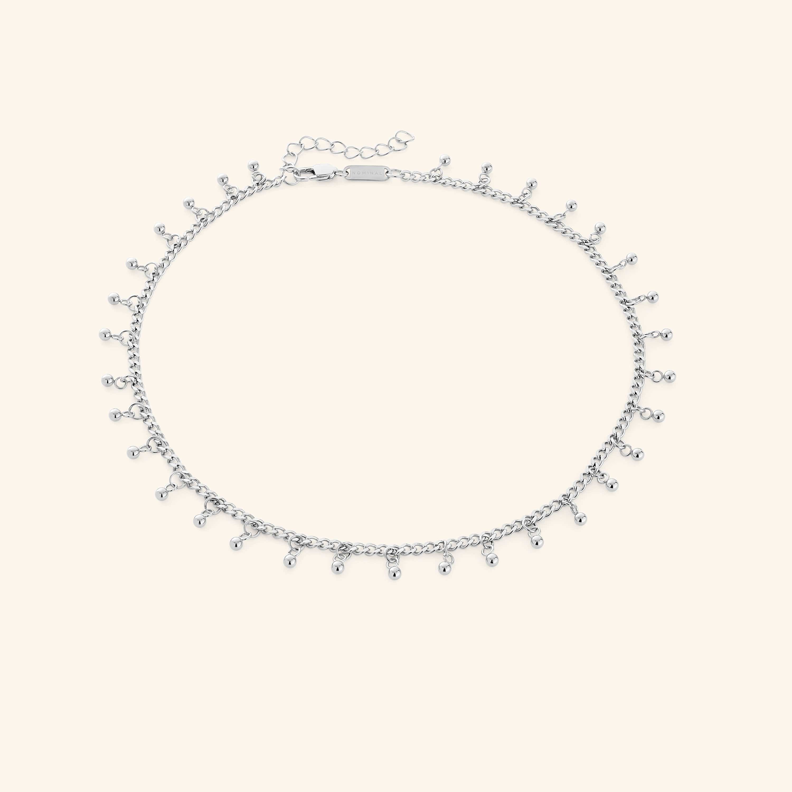 A close-up of the Dangling Dotted Choker in silver. The choker features a delicate chain with evenly spaced 3mm spherical bead accents that dangle, creating a subtle and elegant design.