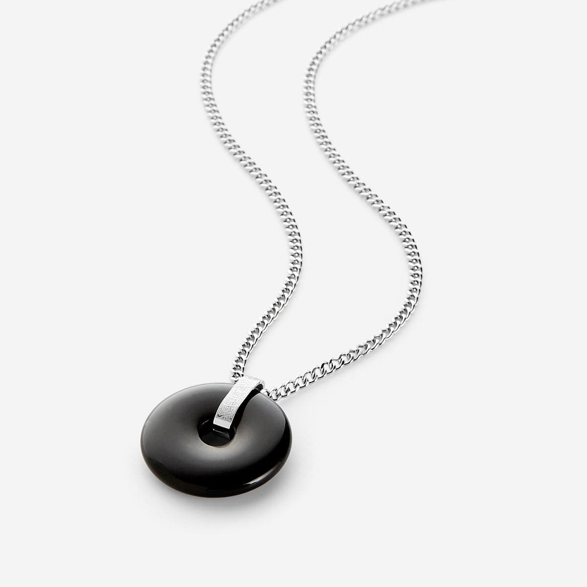 A men’s necklace featuring a black onyx circular stone pendant on a silver chain, with engraved Arabic calligraphy on the silver bail.