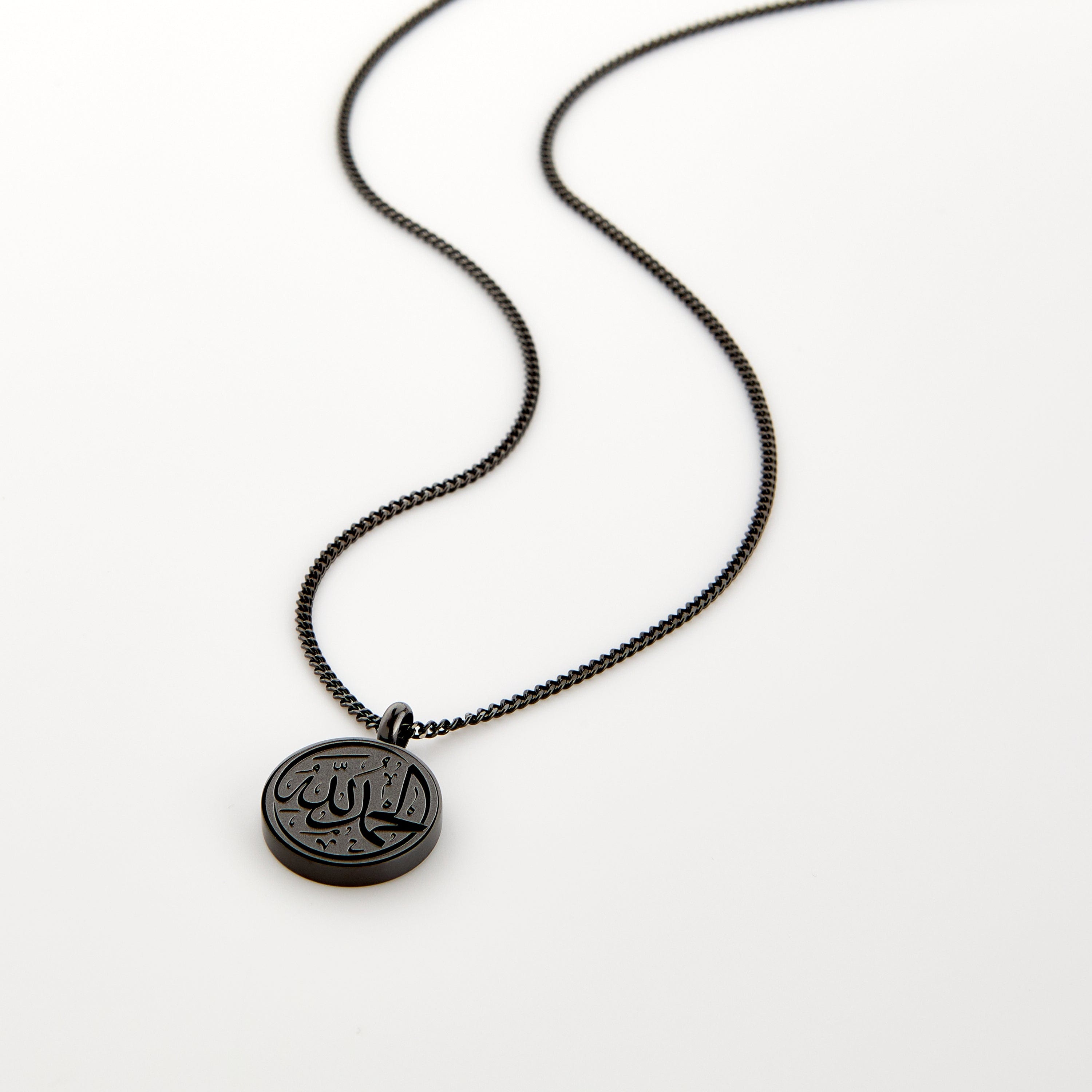 Black necklace with a circular pendant engraved with 'Alhamdulillah' calligraphy, displayed on a white background