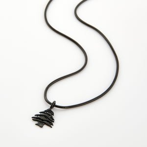 Black necklace with a Cedar of Lebanon tree pendant, displayed on a white background.