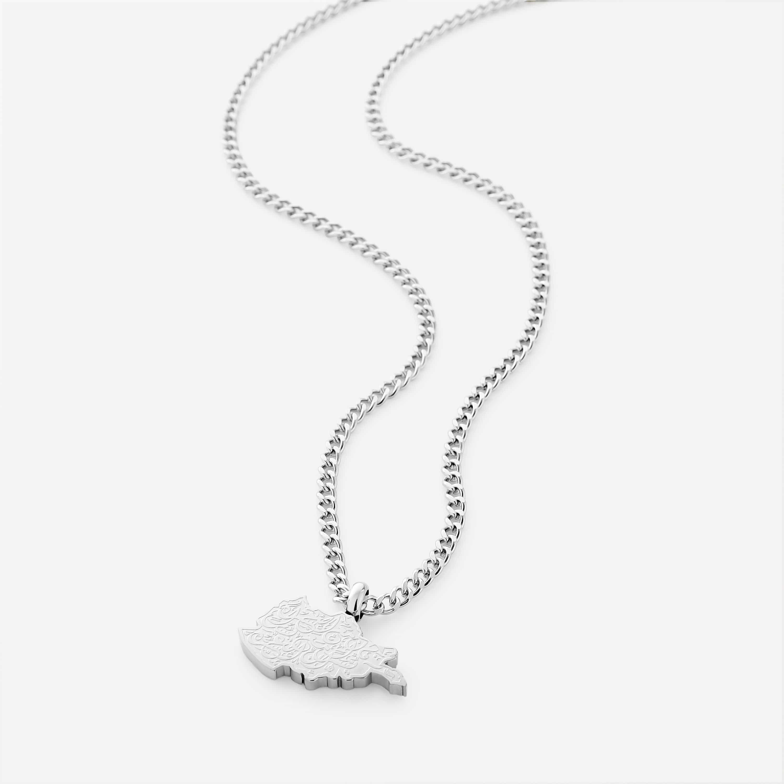 Silver necklace with an afghanistan map-shaped pendant with arabic calligraphy engraved, shot on a white background