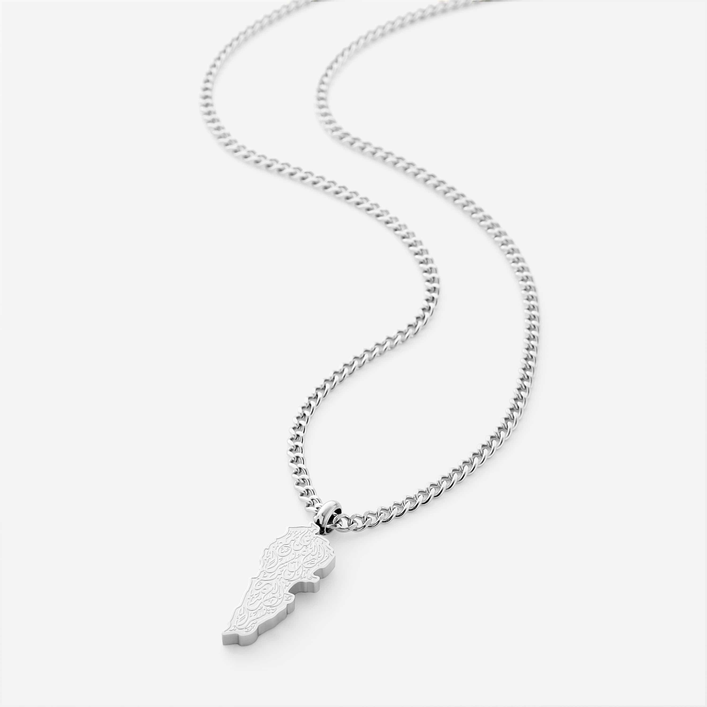 Silver necklace with a lebanon map-shaped pendant with arabic calligraphy engraved, shot on a white background
