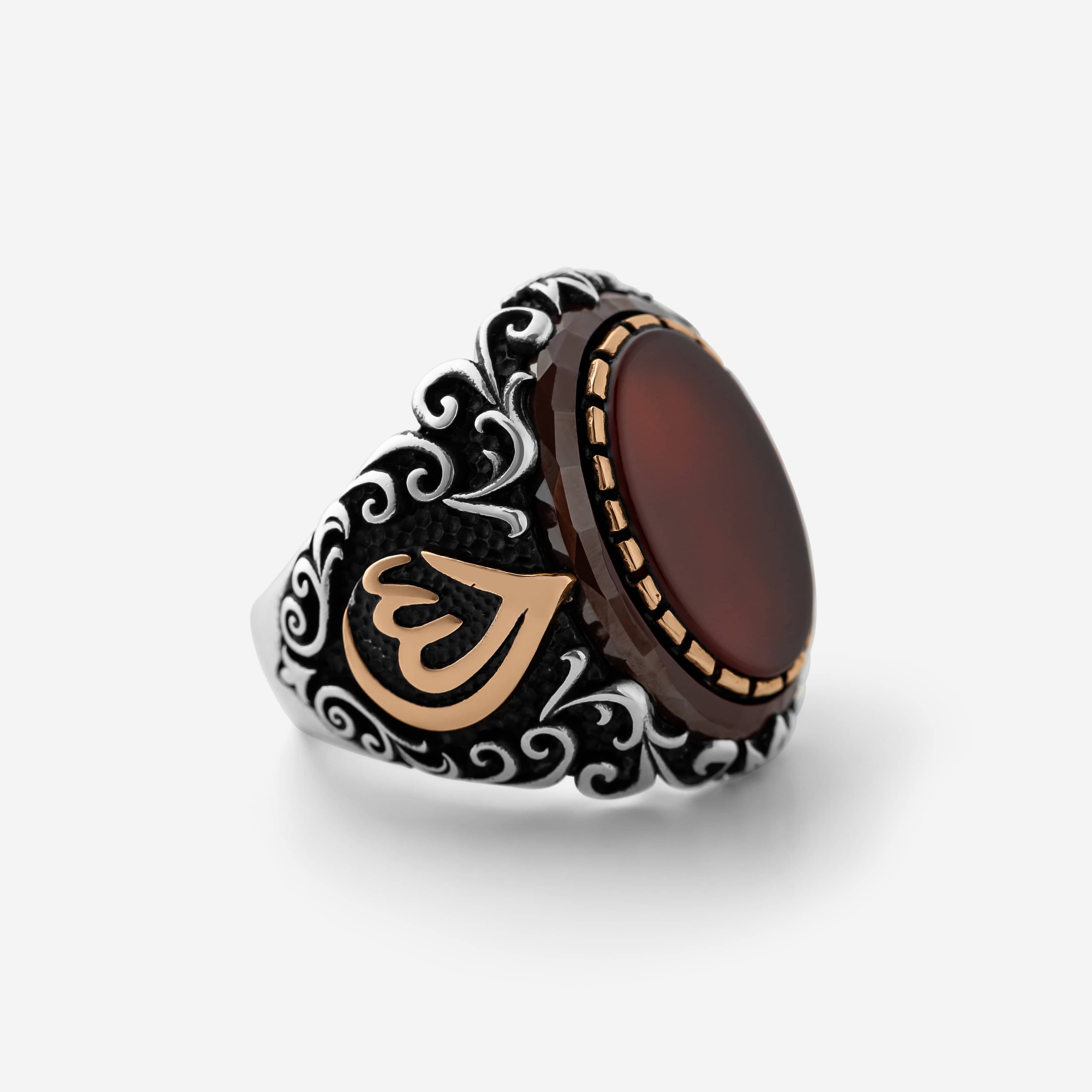 Men’s silver ring with a red agate stone and an Arabic calligraphy detail of the word ‘Allah,’ surrounded by ornate black and silver engravings.