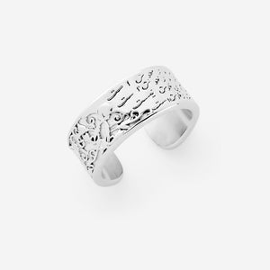 A wide silver open ring split between two worlds: one side carved with Kalim Kashani's poem reminding you to find joy in the present moment between each wave, the other carved out of the metal with florals that feel alive.
