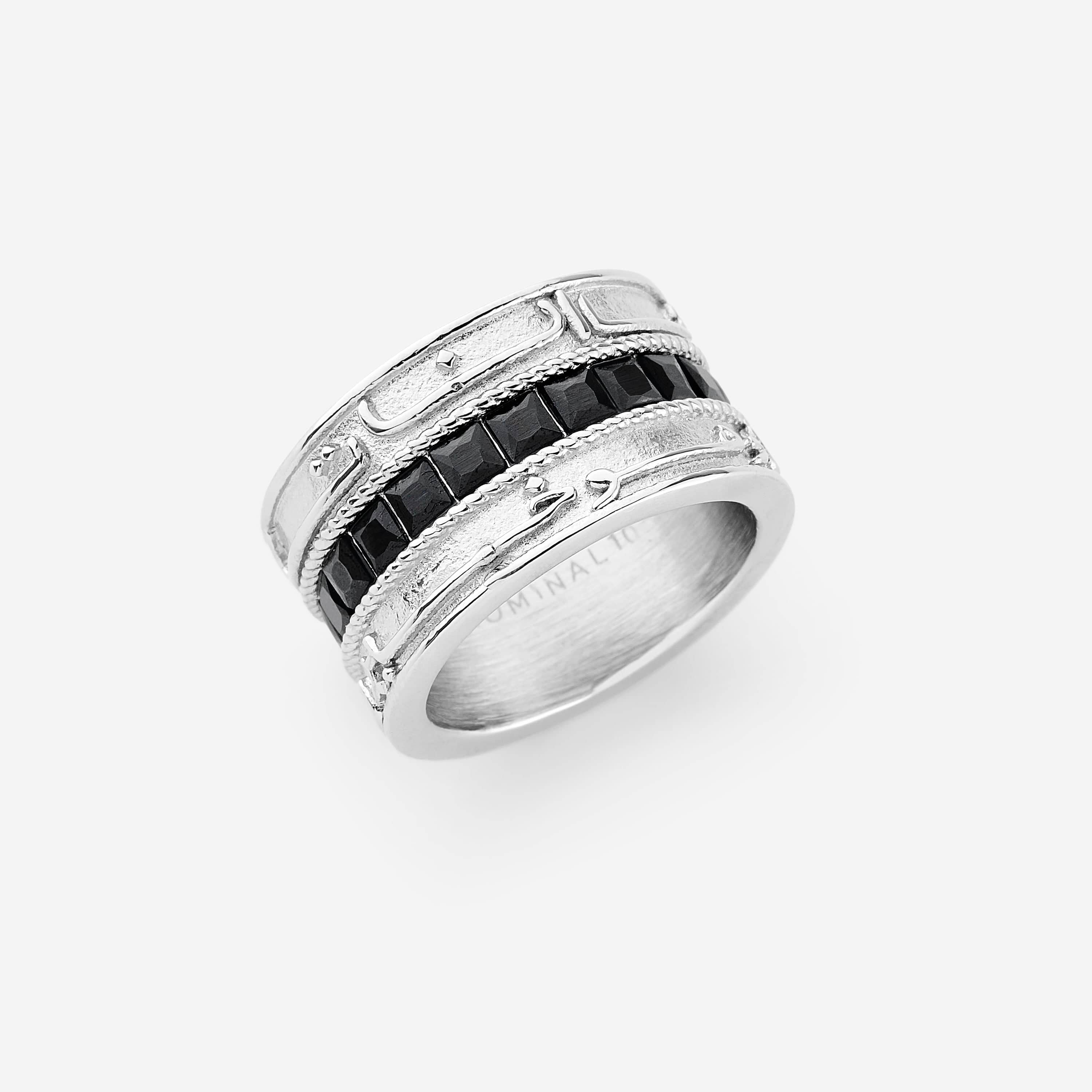 A silver ring that features a wide band carved with part of verse 2:216 from the Qur'an: "Perhaps you dislike what is good for you" and onyx stones set at the center.