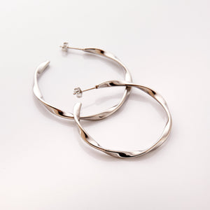 The silver Ripple Hoop Earrings against a white background.