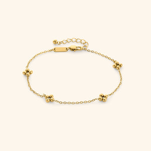 Gold Dotted Henna Anklet shot on a cream background, featuring a delicate chain with evenly spaced dotted floral clusters and adjustable clasp.