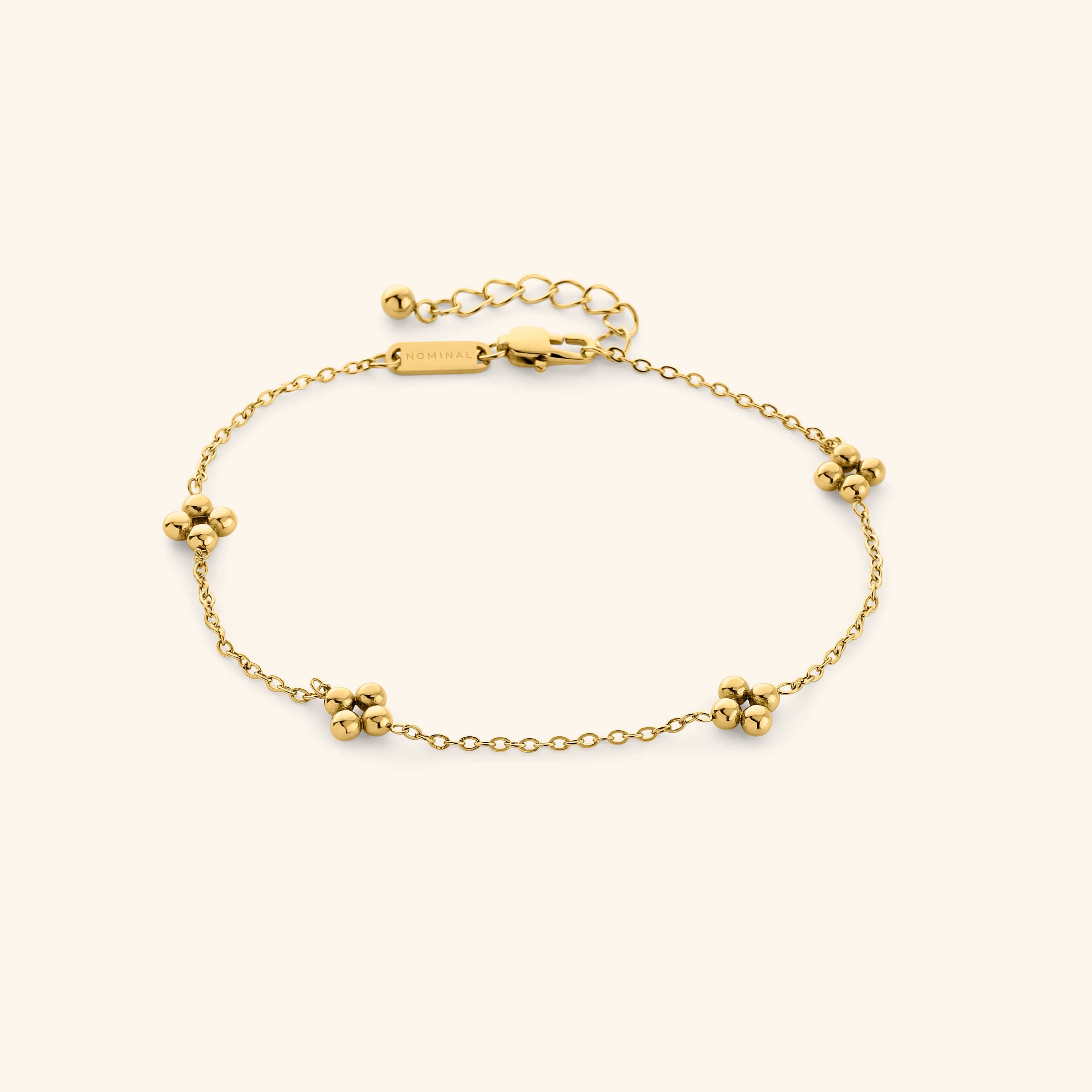 Gold Dotted Henna Anklet shot on a cream background, featuring a delicate chain with evenly spaced dotted floral clusters and adjustable clasp.
