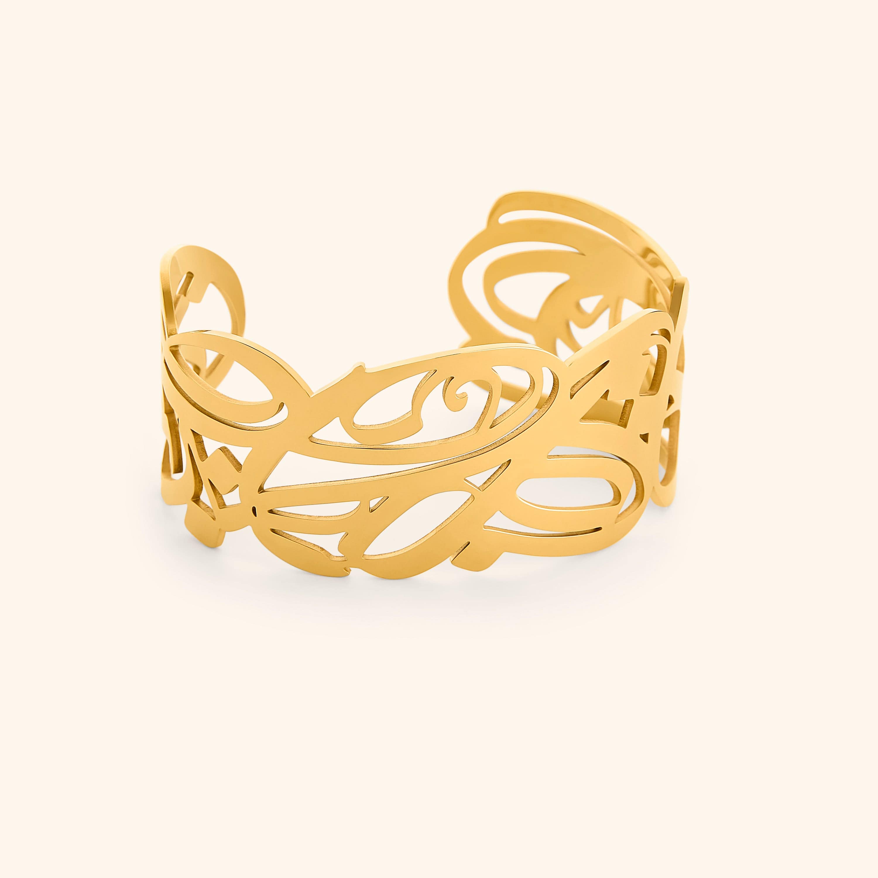 A gold cuff bracelet with intricate, swirling cut-out designs. The bracelet is wide and open-ended, and the delicate patterns create a lacy or filigree effect. The text "GRACE (Cuff) | Aadil x Nominal" indicates this is a product shot of the "Grace" cuff bracelet, a collaboration between Aadil and Nominal.