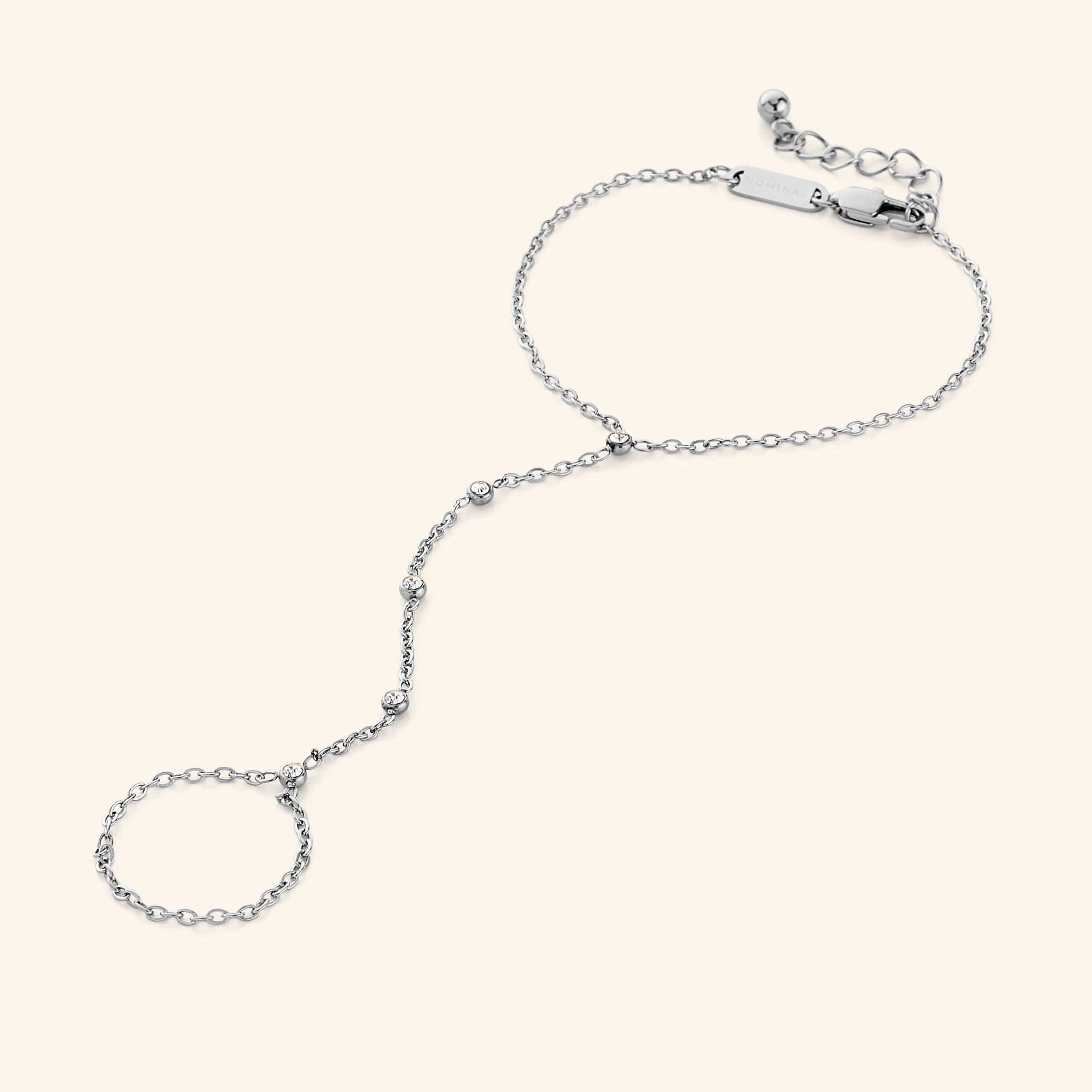 Close-up of the Diamond Path Hand Chain in polished silver, showing the delicate chain with five bezel-set 3mm cubic zirconia stones, designed to connect a ring to the wrist.