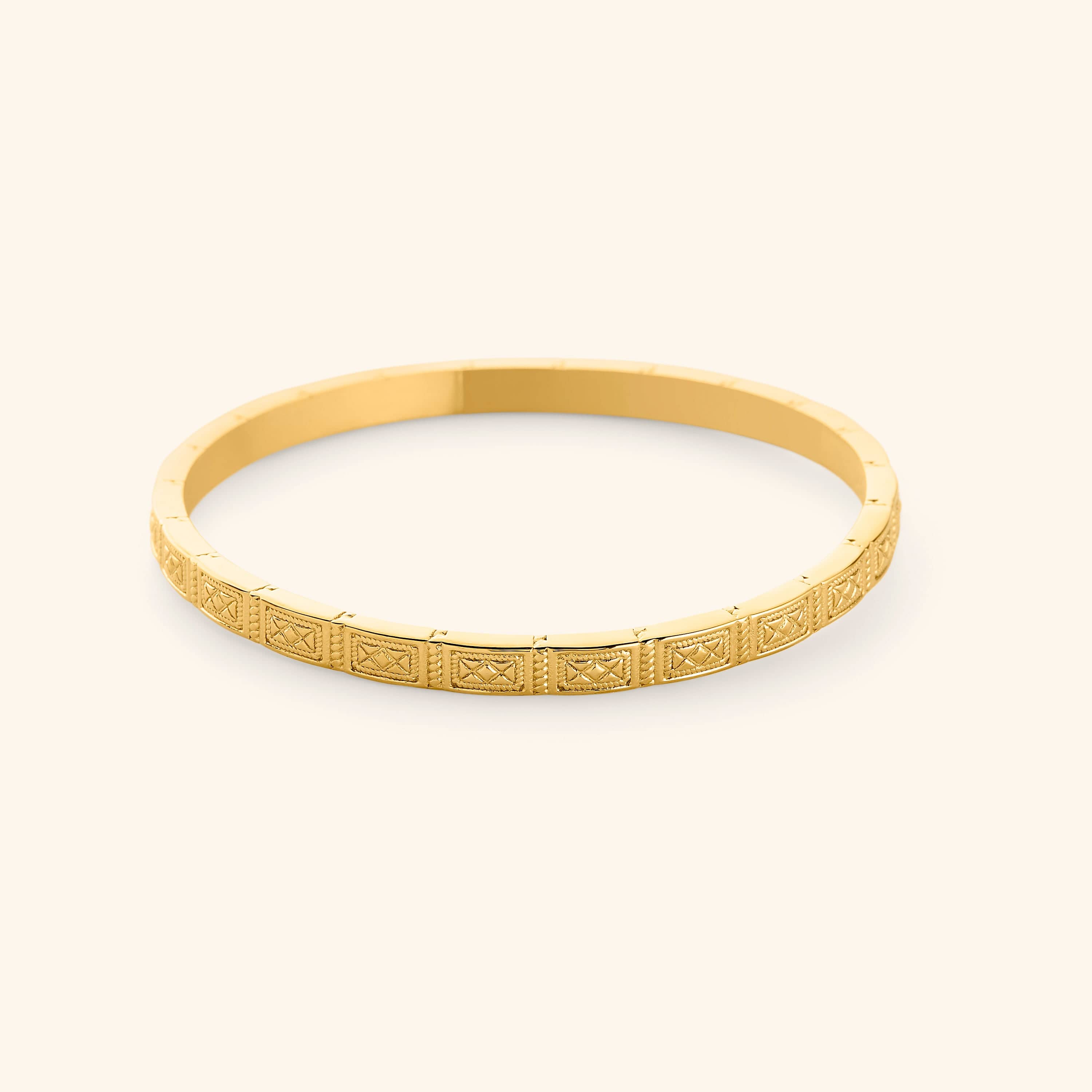 A slim 18k gold plated bangle etched with geometric patterns pulled from Damascus tilework.