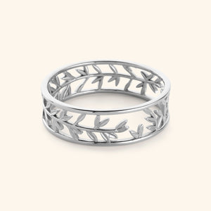 Silver Eternal bangle featuring olive leaves pattern against light background