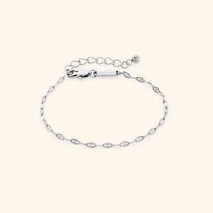 Flat lay of silver version of the flutter chain bracelet with extender.