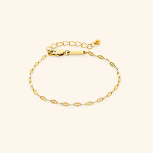 Flat lay of gold flutter chain bracelet with extender chain.