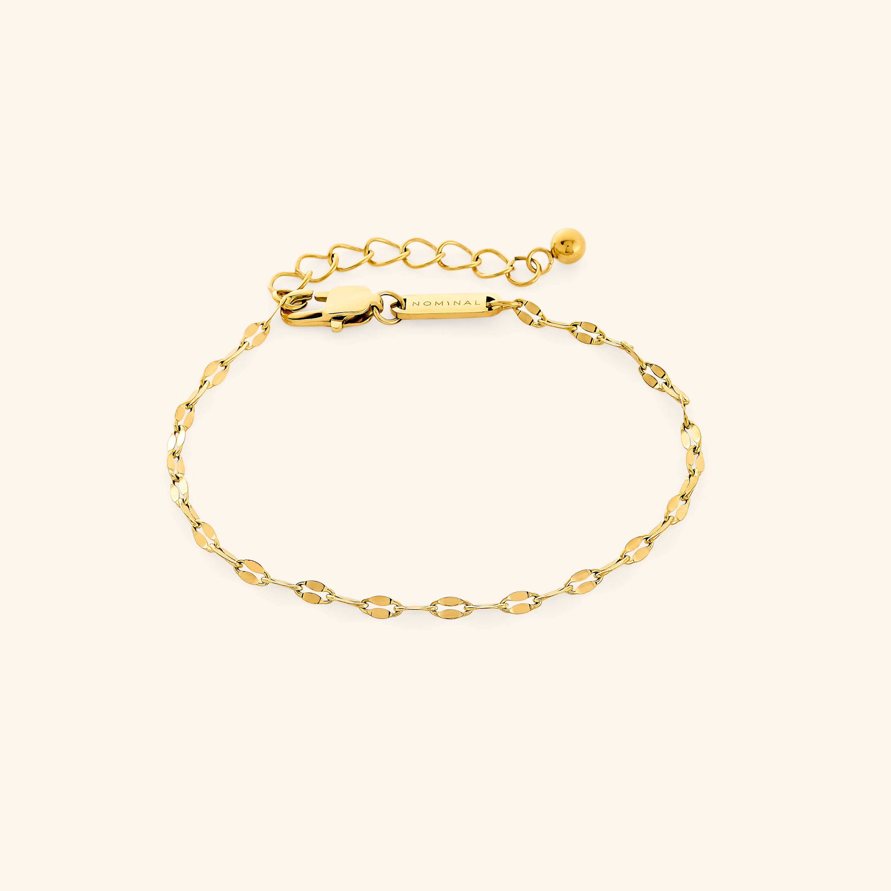Flat lay of gold flutter chain bracelet with extender chain.