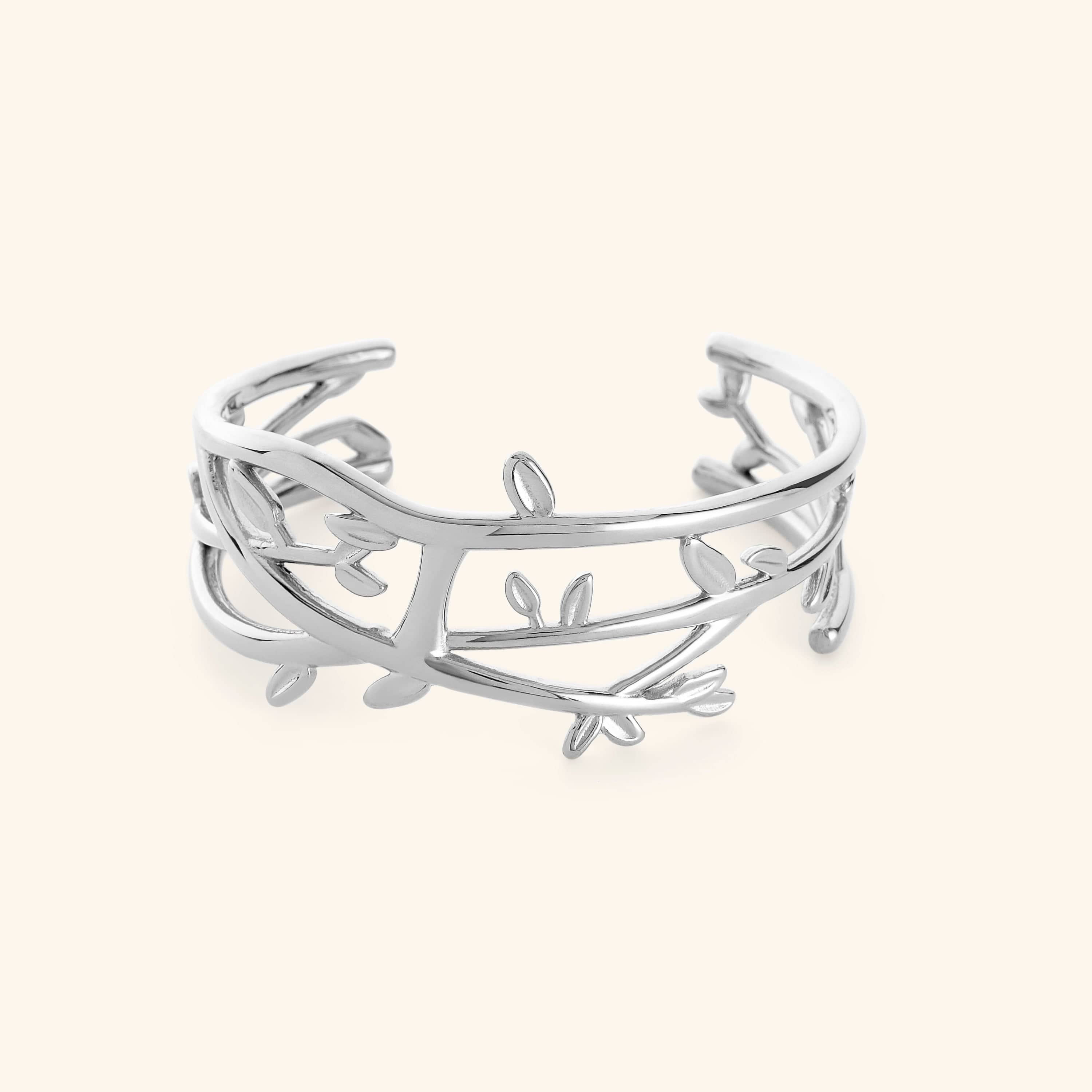 Silver Imperfect Olive branch cuff on a light background