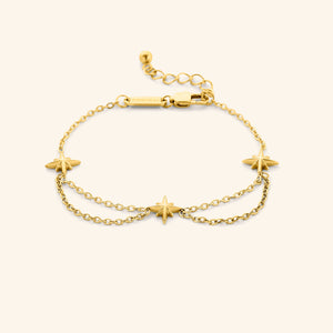 An 18k gold plated bracelet that features north stars all along the chain, drooping chains connecting each one design.