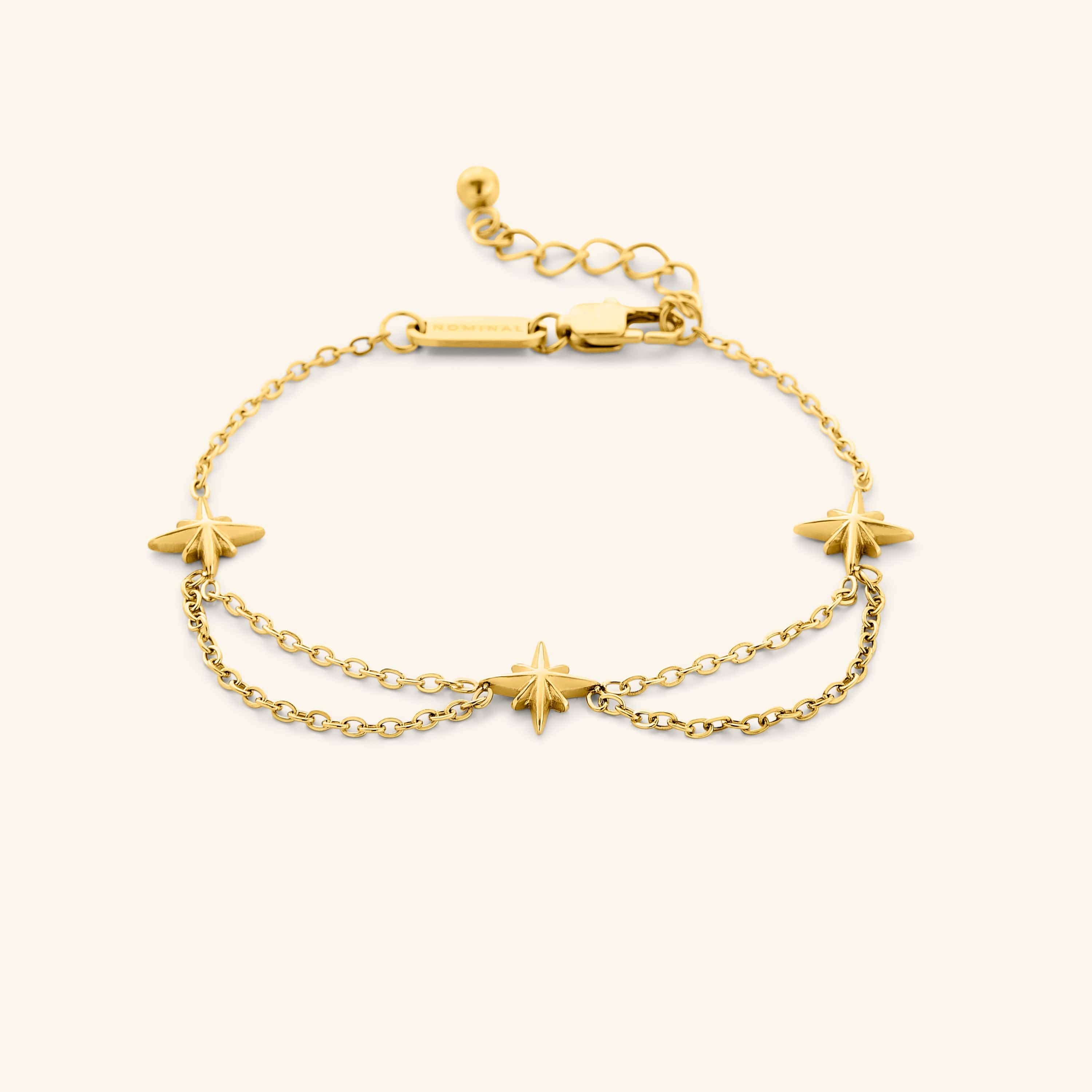 An 18k gold plated bracelet that features north stars all along the chain, drooping chains connecting each one design.
